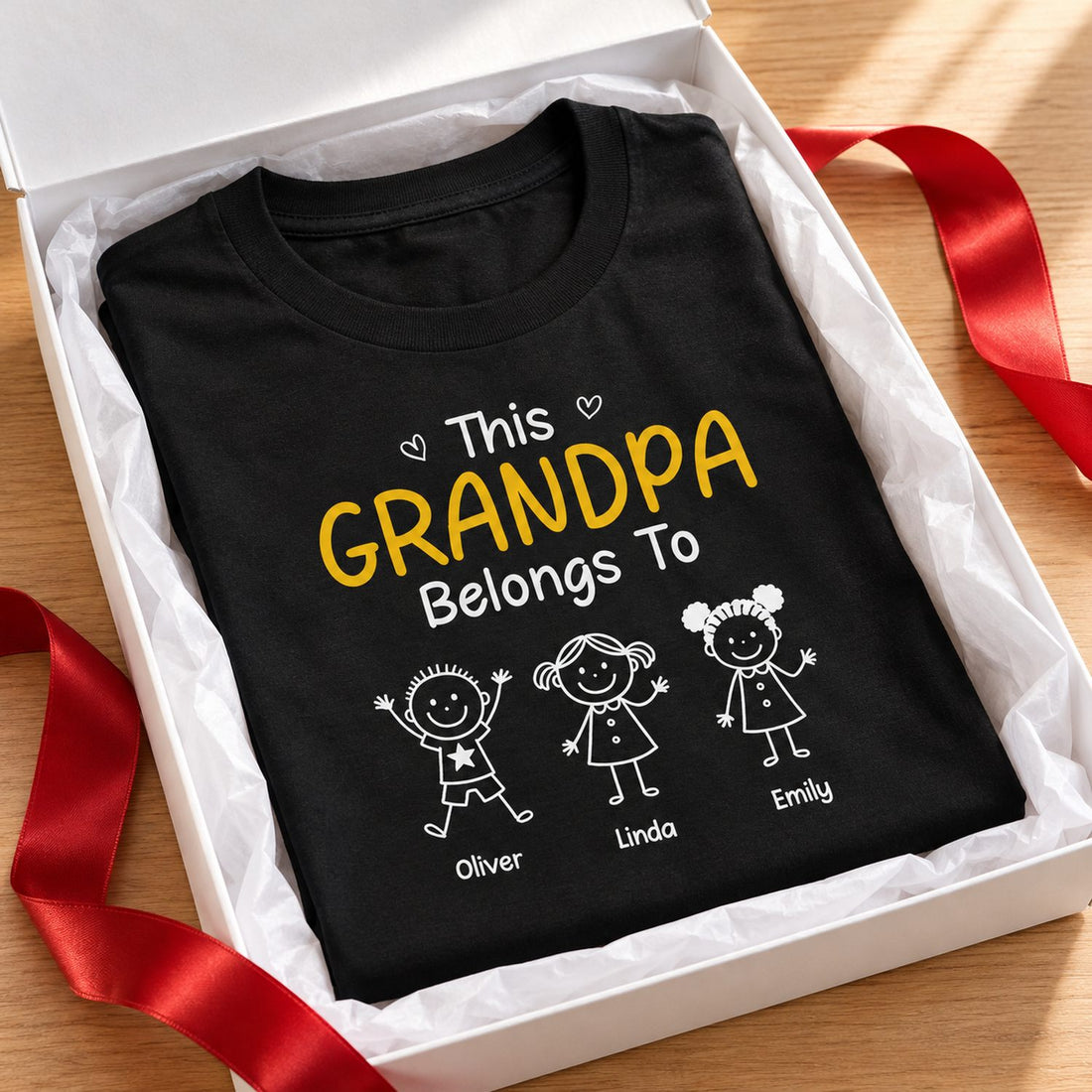 Personalized This Grandpa Belongs To black t-shirt folded in a holiday gift box with red ribbon