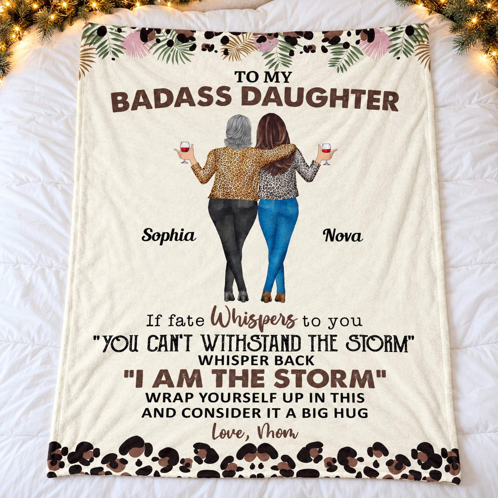 Personalized daughter blanket spread flat on a cozy bed with holiday garland