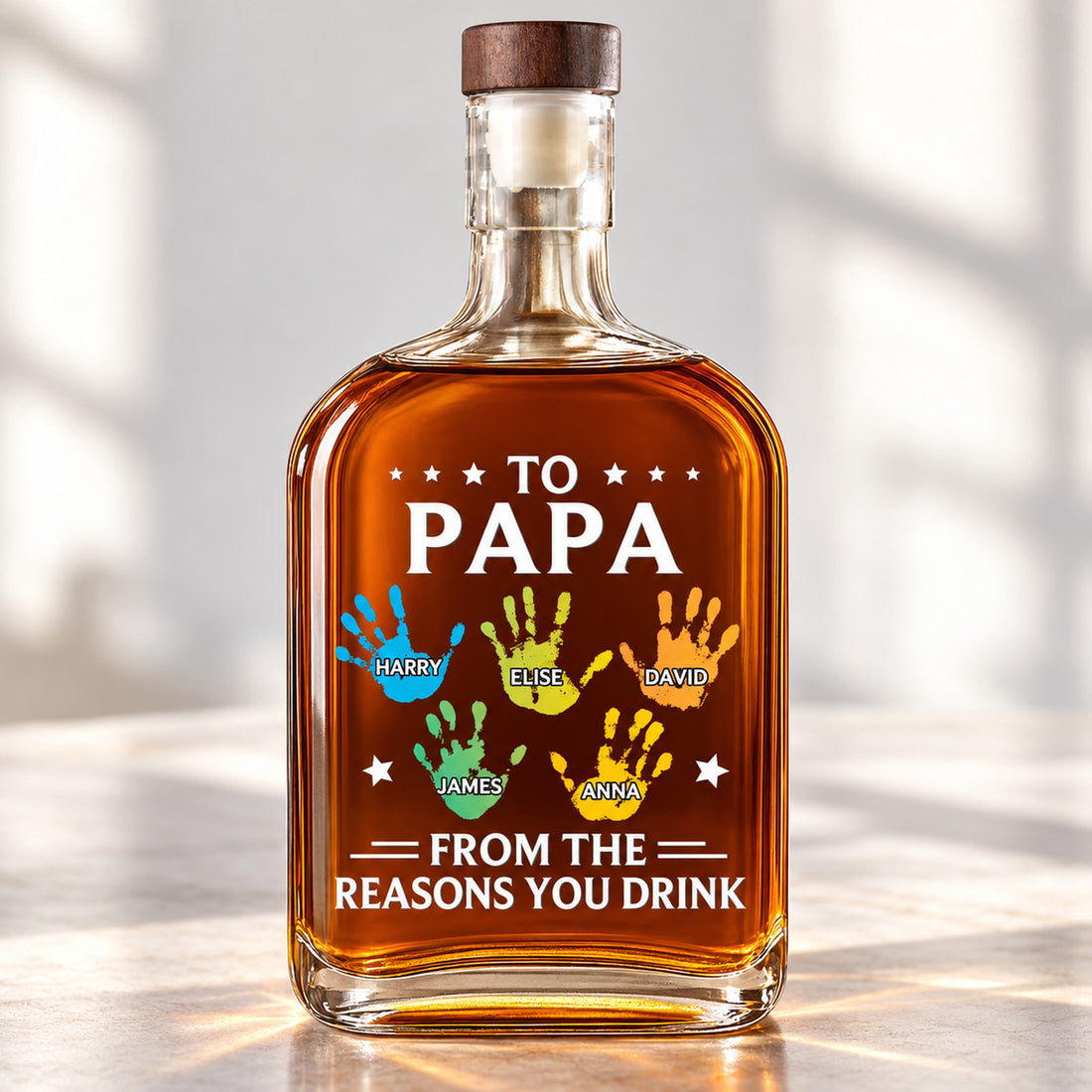 Close up detail of colorful printed handprints and names on personalized Papa whiskey bottle