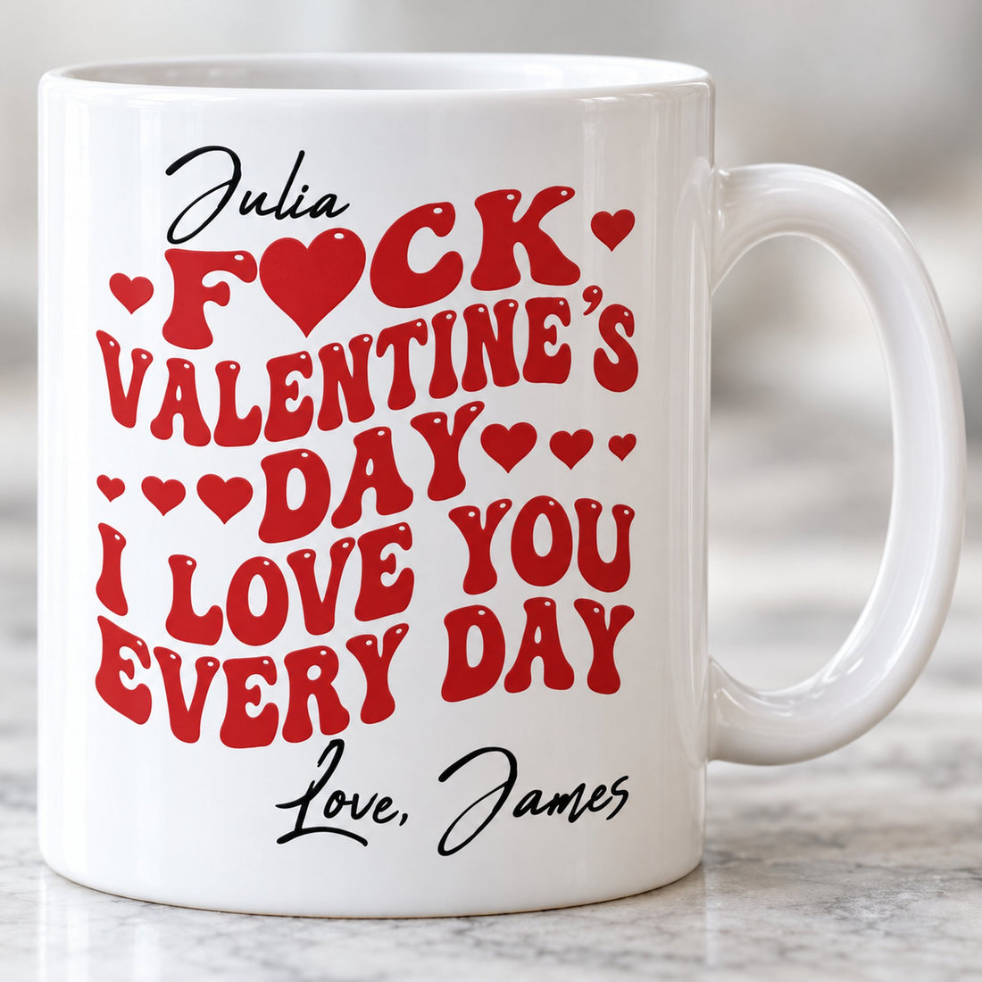 Close up detail of glossy ceramic mug print with red wavy letters and custom names