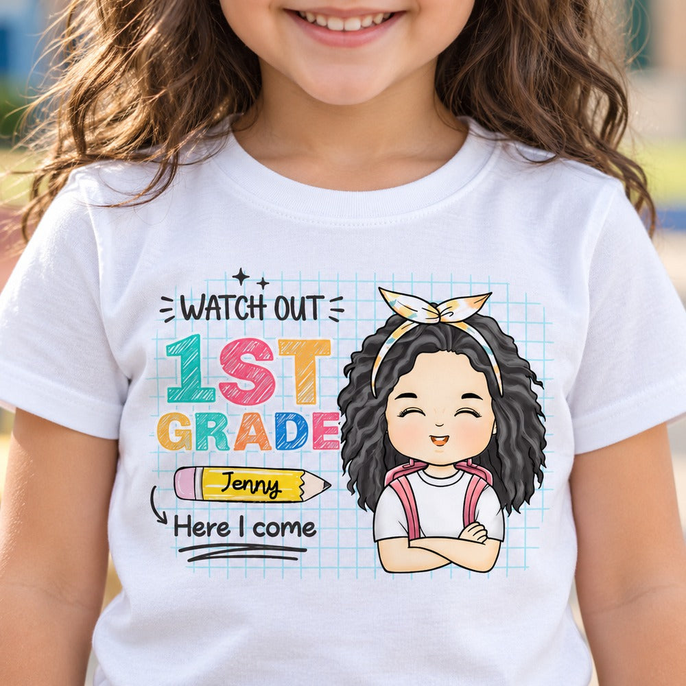 Close-up detail of custom 1st grade pencil and cartoon girl print on white youth shirt