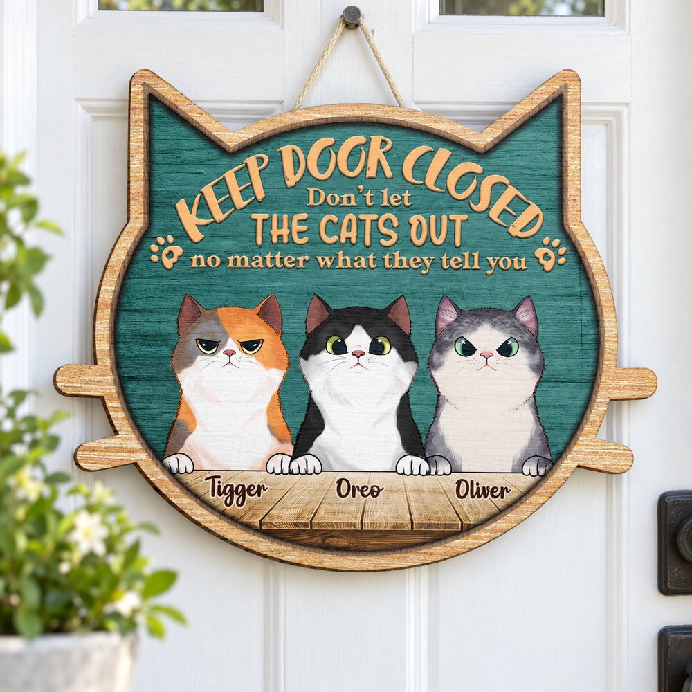 Personalized peeking cats custom shaped wood sign hanging on a white front entryway door