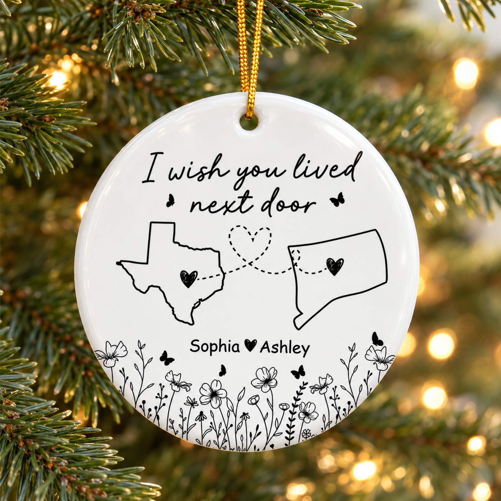 Wish You Lived Next Door personalized ceramic ornament hanging on a Christmas tree branch