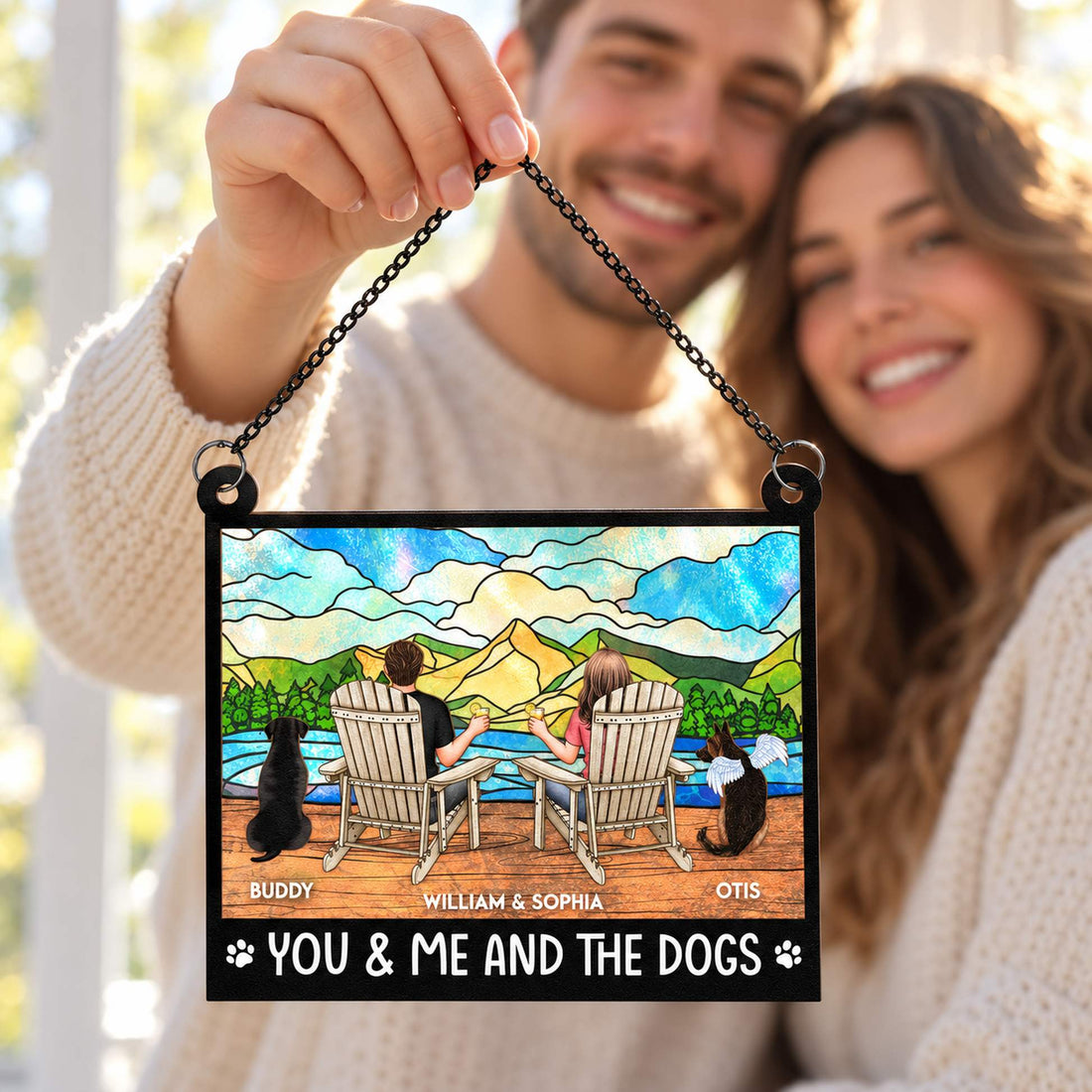Couple holding personalized dog lovers window hanging suncatcher by a bright window