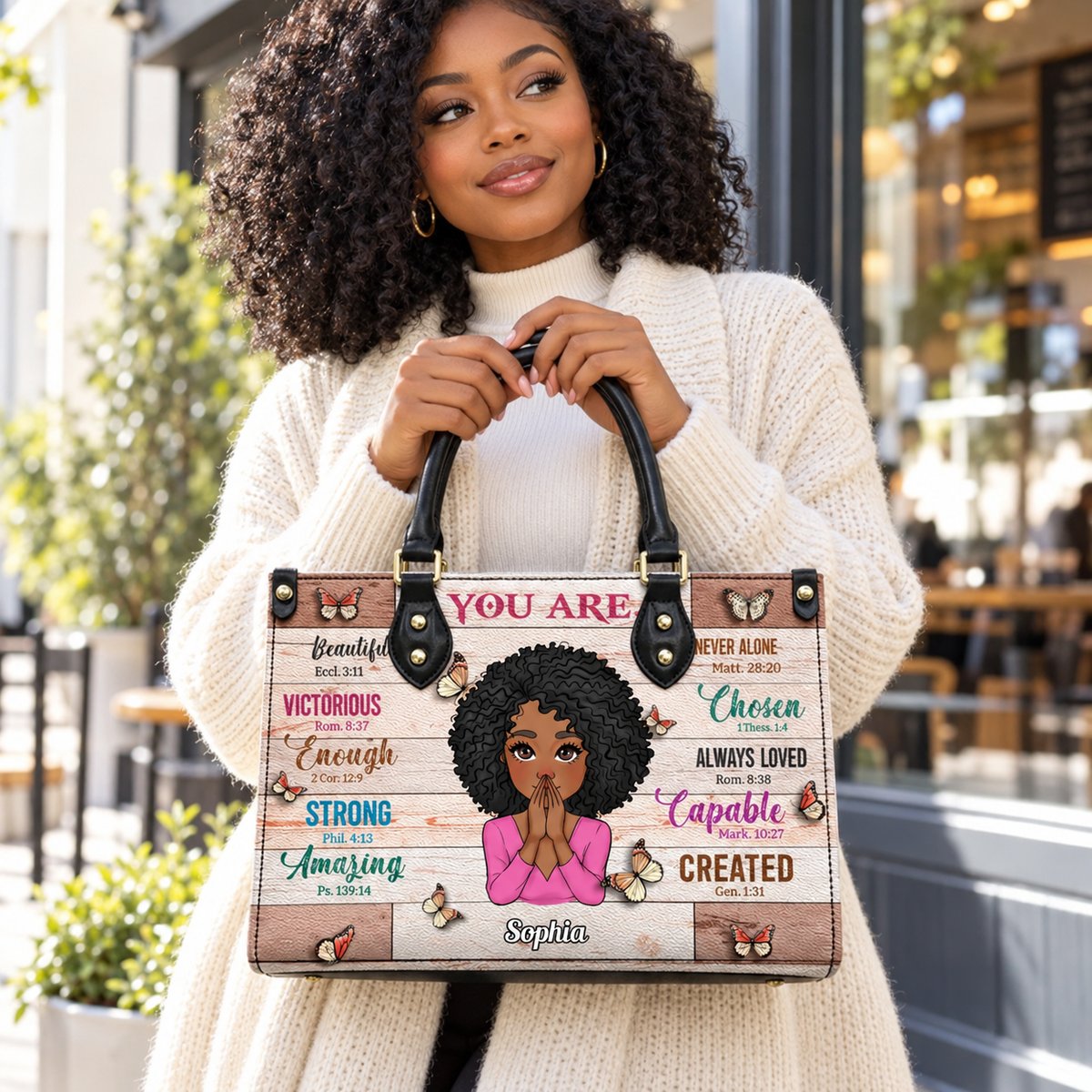 Black woman carrying custom Christian PU leather handbag with Bible verses in daylight