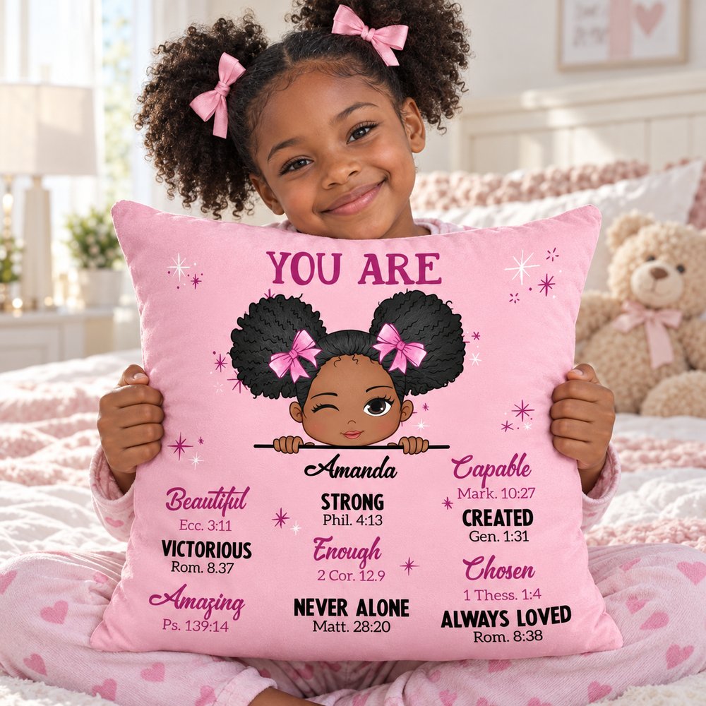 Young girl hugging her personalized pink You Are Bible Verses custom pillow on her bed