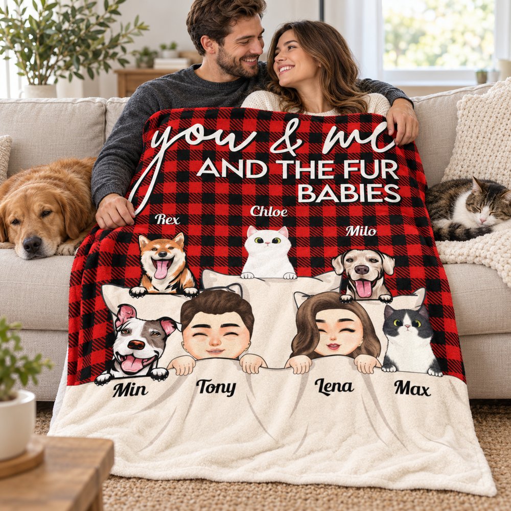 Couple and pets on a sofa wrapped in personalized You and Me And The Fur Babies buffalo plaid blanket
