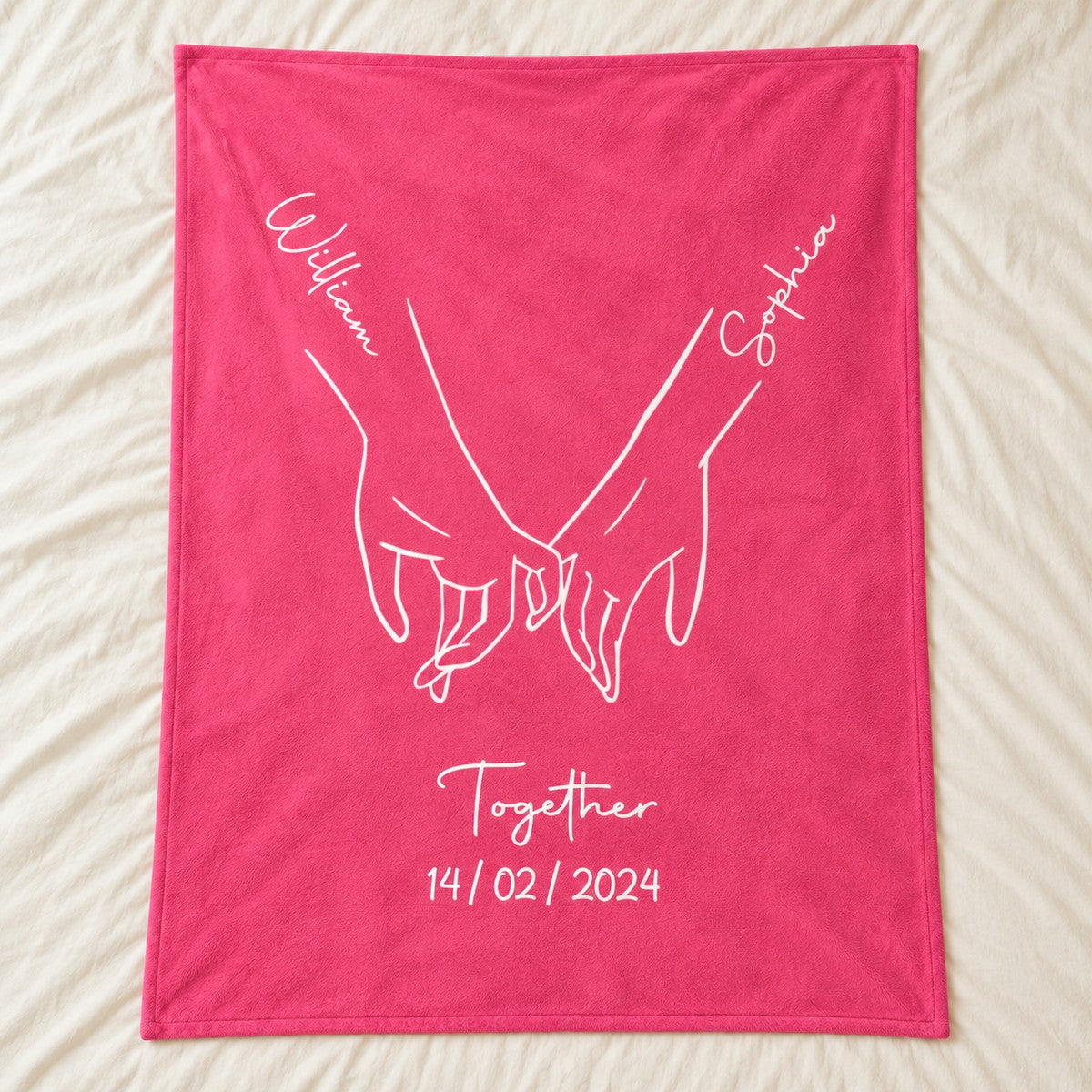 Personalized couple fleece blanket with holding hands print spread flat on a cream bed
