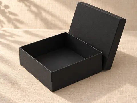 Black gift box with the lid lifted off